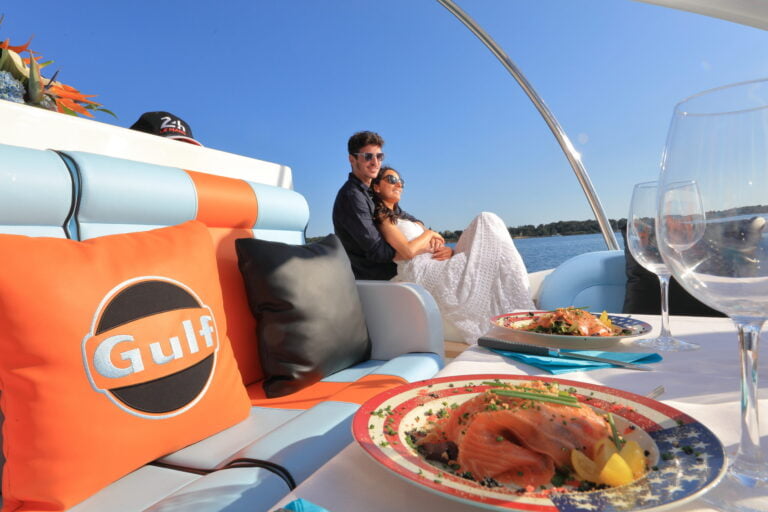 A cute couple enjoying saumon and caviar in the boat