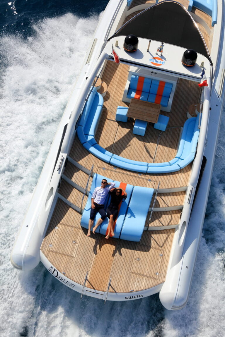 Top view of the cruising yacht Yes Darling, with two people hanging on the deckchairs